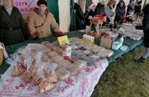 stoisko z ciastami w tle grupa osob przy kolejnym stoisku